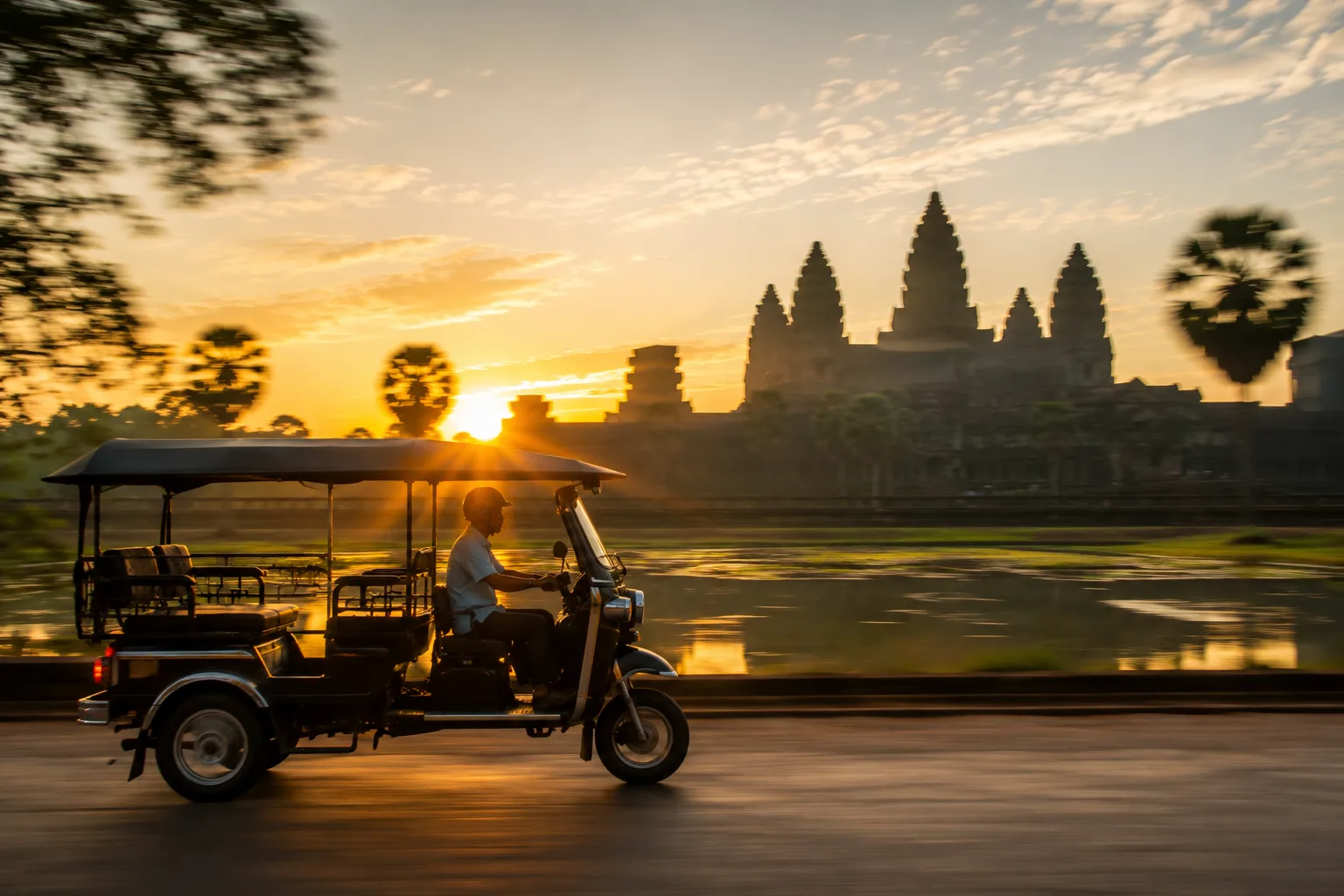 Tuk-tuk stationne face a Angkor Wat au lever du soleil